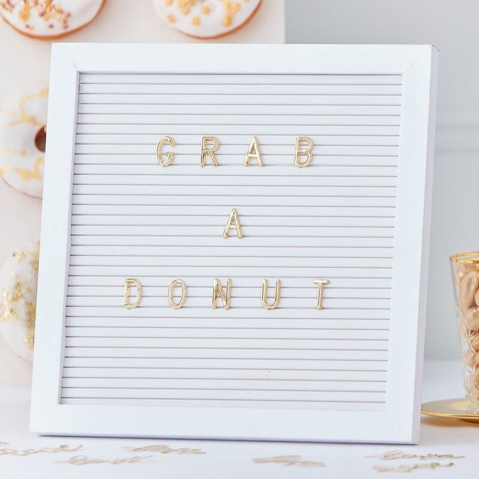 White peg board with Gold letters